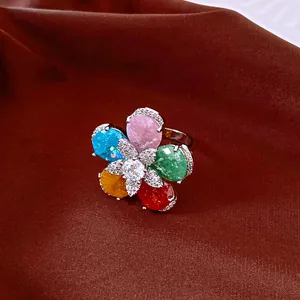 Close-up detail of a sparkling multi-color zircon flower ring with 18k gold plating finish