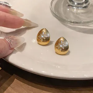 Détail de boucles d'oreilles gouttes plaquées or 18k ornées d'une étoile en zircon