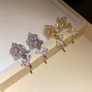 Elegant 14k gold plated flower clip earrings with sparkling zircon stones in a box