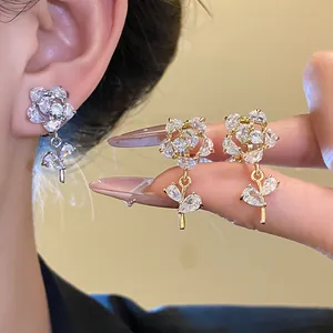Close-up of 14k gold plated zircon flower ear clips showing detailed sparkle and design