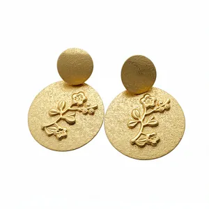 Gold textured circular stud earrings featuring floral branch design and S925 silver posts