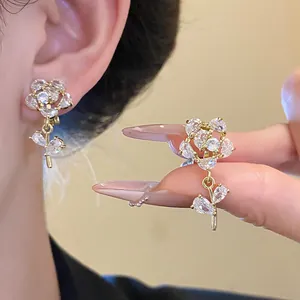Elegant 14k gold plated flower clip-on earrings featuring sparkling cubic zirconia stones