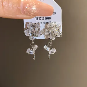 Detailed macro shot of 14k gold plated cubic zirconia flower clip-on earrings with sparkle