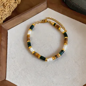 Detail view of a bohemian beaded bracelet with earthy stone beads and gold-tone spacers