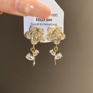 Close-up of elegant flower clip-on earrings with 14k gold plating and zirconia crystals.