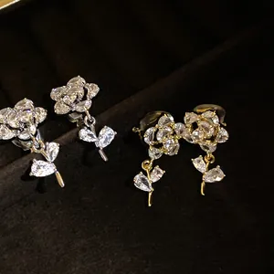 Detailed view of elegant 14k gold plated flower clip-on earrings with zircons