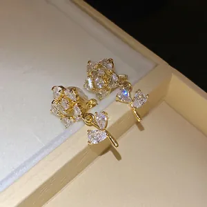 Exquisite 14k gold plated zircon flower clip-on earrings featuring elegant leaf details.