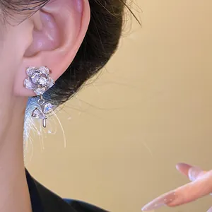 Close-up shot of a sparkling zircon flower ear clip elegantly worn on a delicate earlobe.