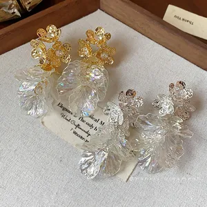 Elegant 18k gold plated flower stud earrings with iridescent tassel petals on canvas
