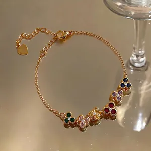 Elegant vintage gold plated bracelet featuring colorful floral charms with sparkling zircons