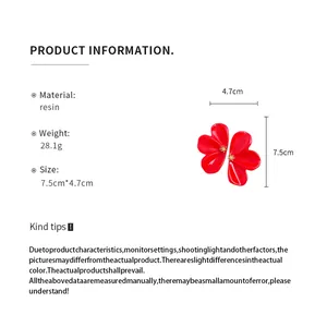 Product details for red resin flower earrings showing size and material information