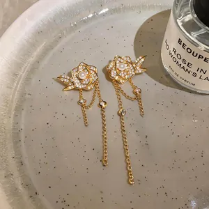 Detaillierte Ansicht der 18K vergoldeten Blumenohrringe mit Zirkonia und Quasten.