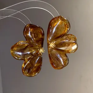 Macro view of elegant amber resin flower earrings with delicate gold center details