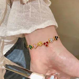 Detailed view of a vintage-style gold bracelet with multi-colored zircon flower charms