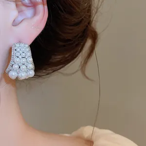Detail shot of French vintage silver earrings featuring elegant pearls and sparkling zircons