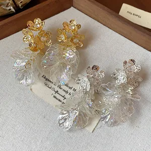 Detailed view of iridescent flower petal earrings with zircon accents in gold and silver finish
