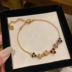 Detailed view of gold-plated bracelet featuring multi-colored zircon flower charms.