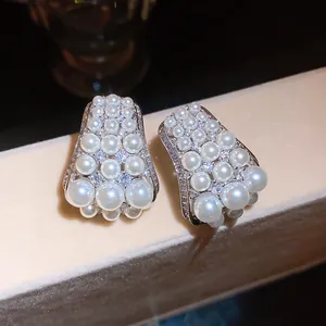 Detail view of French retro earrings with white pearls and sparkling zircons