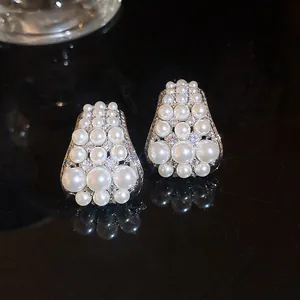 Close-up of French vintage zircon pearl stud earrings with elegant luster and shine
