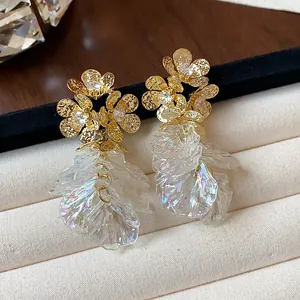 Close-up of 18k gold plated zircon flower earrings featuring iridescent petal tassels