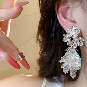 Detailed macro shot of 18k gold plated flower tassel earrings with zircon accents