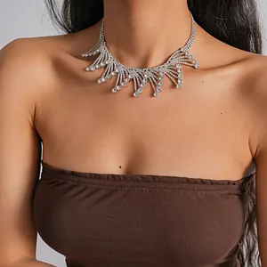 Elegant rhinestone scalloped fringe necklace with intricate hollow design on model