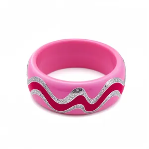 Vibrant pink resin bangle featuring wavy silver filigree and crystal embellishments