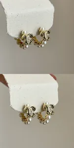 Close-up detail of vintage gold hoop earrings with zircon butterfly and small pearls