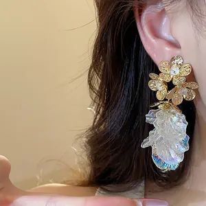 Close-up detail of 18k gold plated flower tassel earrings with zircon and petals