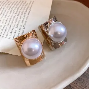 Elegant gold and silver minimalist wide band rings featuring large round white pearls