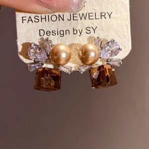 Elegant vintage zircon and pearl stud earrings featuring amber square crystals on card