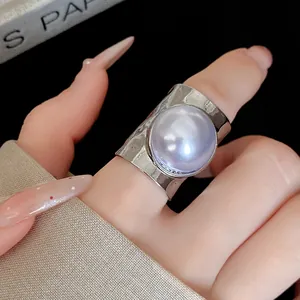 Detail view of stylish wide-band ring with large lavender pearl center