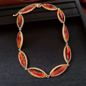 Detailed view of retro marquise-cut amber stones in a textured gold-tone necklace setting