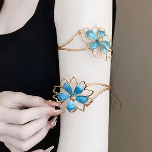 Vintage gold-tone metal arm cuff jewelry with blue enamel flower design for women