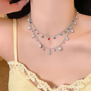 Dettaglio di collana a doppio strato con perline colorate e ciondoli a forma di mare