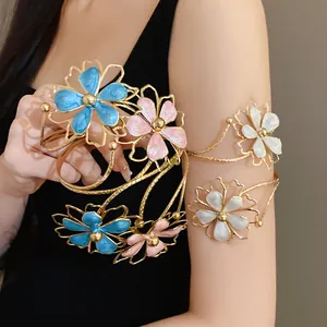 Detailed view of metal armlet with colorful enamel drip oil flowers on woman's arm