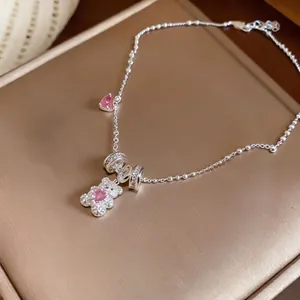 Elegant silver necklace featuring a sparkling zircon teddy bear with a pink heart pendant