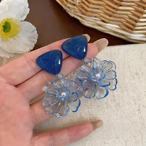 Transparent blue resin flower drop earrings with frosted triangular studs