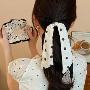 Elegant French style black and white polka dot scrunchie with a long ribbon bow