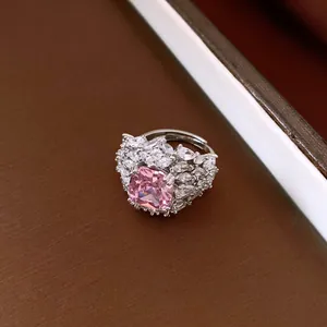 Close-up of luxury adjustable ring with a square pink zircon and clear crystals.