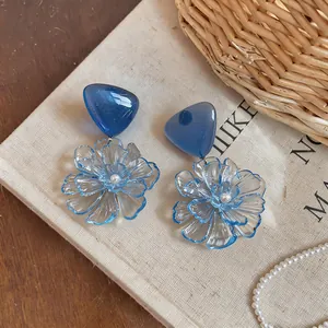 Elegant blue resin flower earrings with frosted petals and pearl center detail
