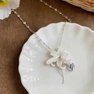 Elegant French style pearl flower necklace with clear drop pendant and heart chain
