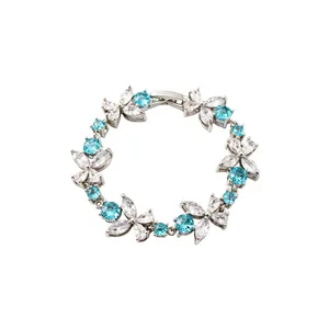 Elegant floral bracelet featuring sparkling blue and white zircons on a silver band.