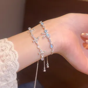 Close-up of silver bracelets with blue heart zircon and star accents on wrist
