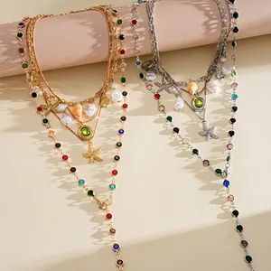 Detailed macro view of resort-style necklaces with pearls, seashells and starfish charms.