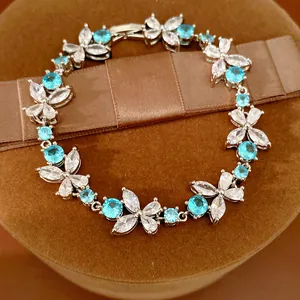 Detailed macro view of an elegant floral link bracelet featuring blue and clear zircon stones