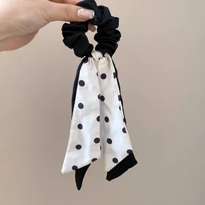 Elegant French style black scrunchie with long white polka dot ribbon for hair decoration