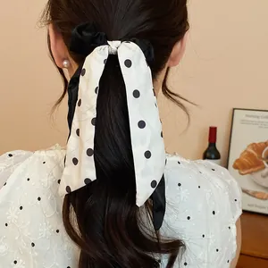 Elegant French style black and white polka dot ribbon hair scrunchie on ponytail detail