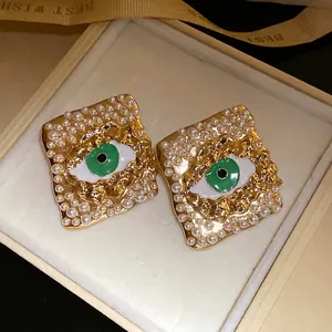 Vintage style square stud earrings with green evil eye and pearl embellishments