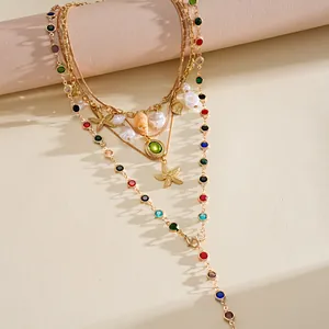 Detailed macro view of bohemian layered necklace with starfish and sea shell charms